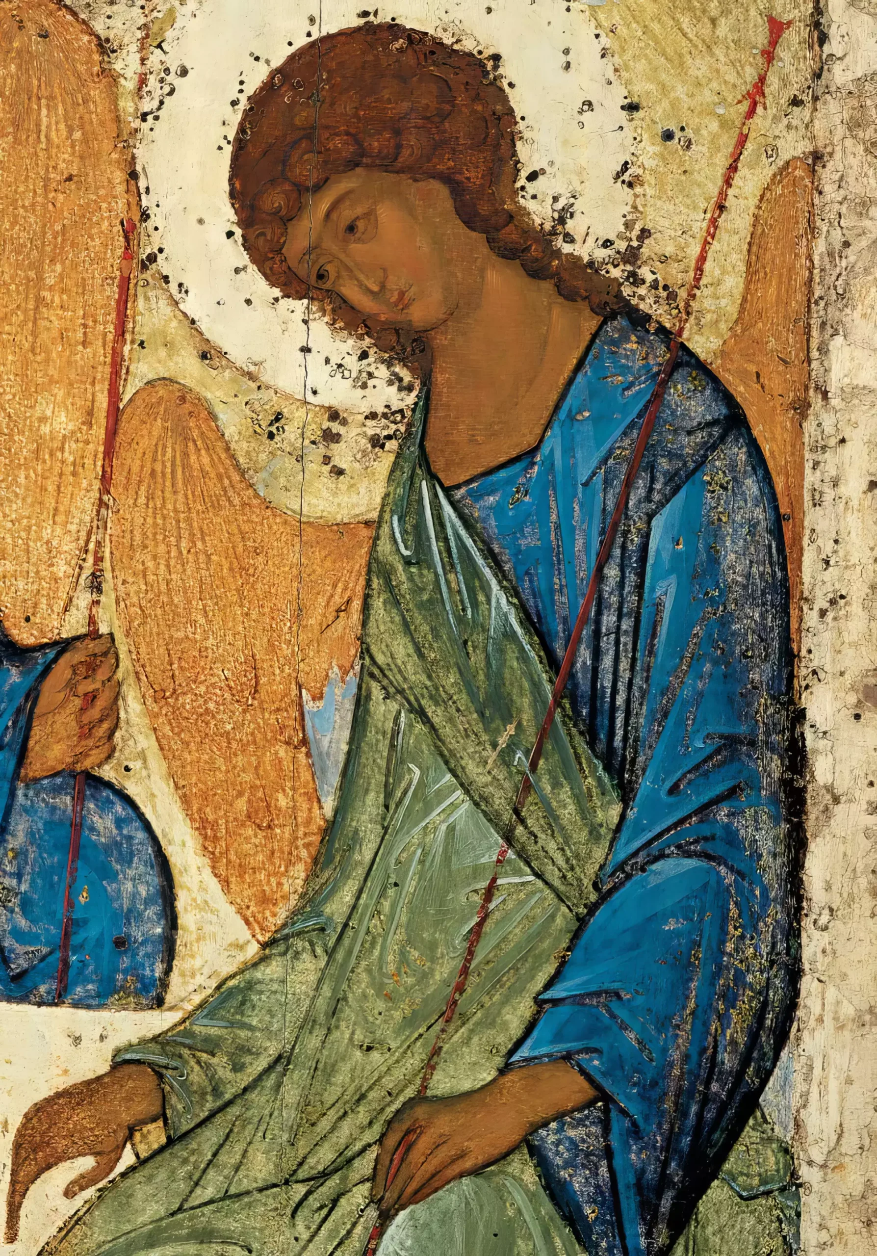 A contemplative detail from Andrei Rublev's Trinity Icon (1425-1427), focusing on the central angel's face and upper body, showcasing the masterful use of blue pigments and gold leaf