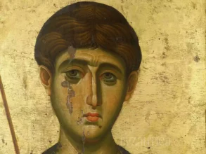 Detailed view of Saint Demetrios in Vatopedi icon showing the saint's face against golden background with expert brushwork