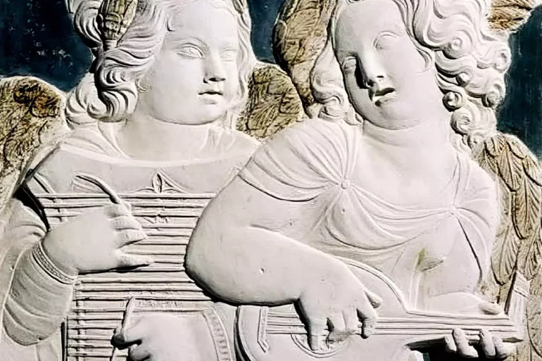 Angels in Sacred Stone: Musical angels playing divine harmonies in white marble relief at Tempio Malatestiano